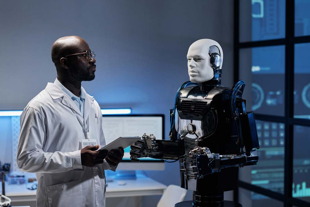 Engineer working on automated decision-making technology on tablet pc in office, next to a robot